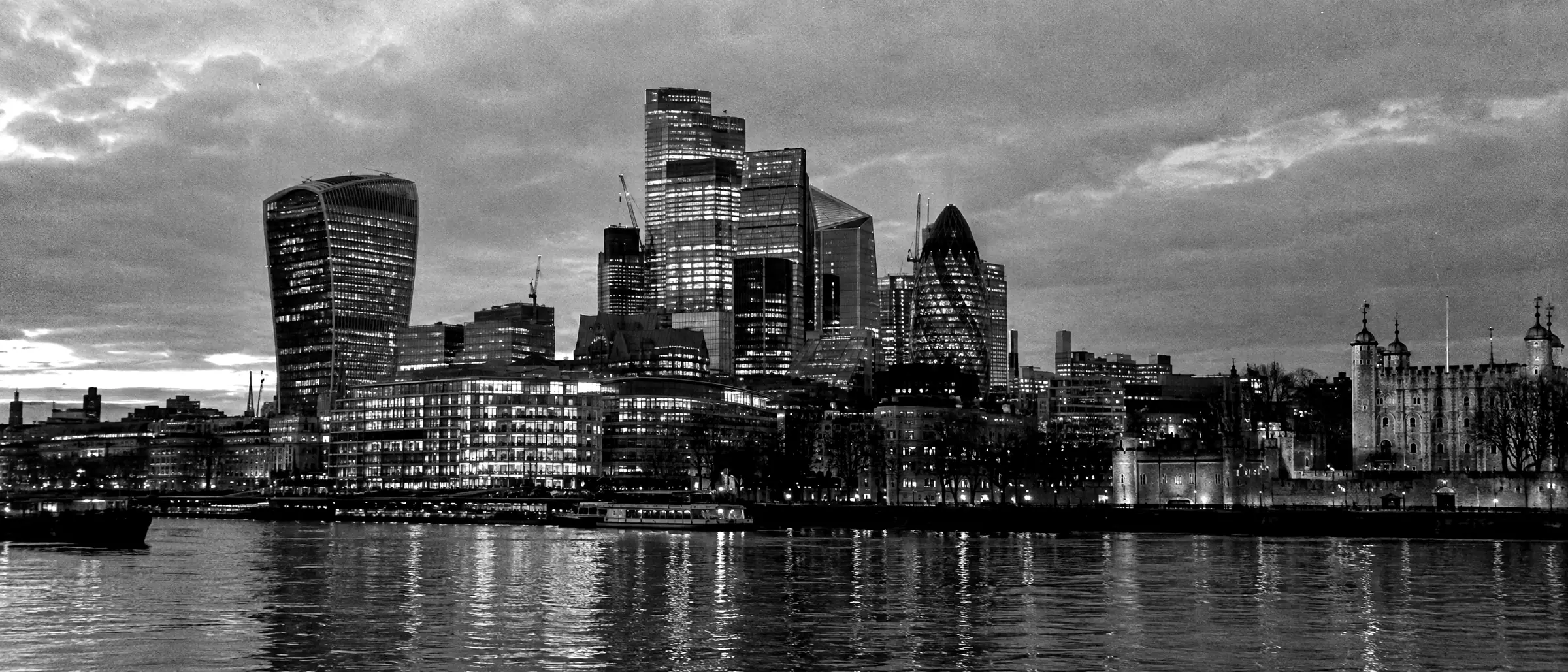 The City of London skyline at dusk, seen across the River Thames