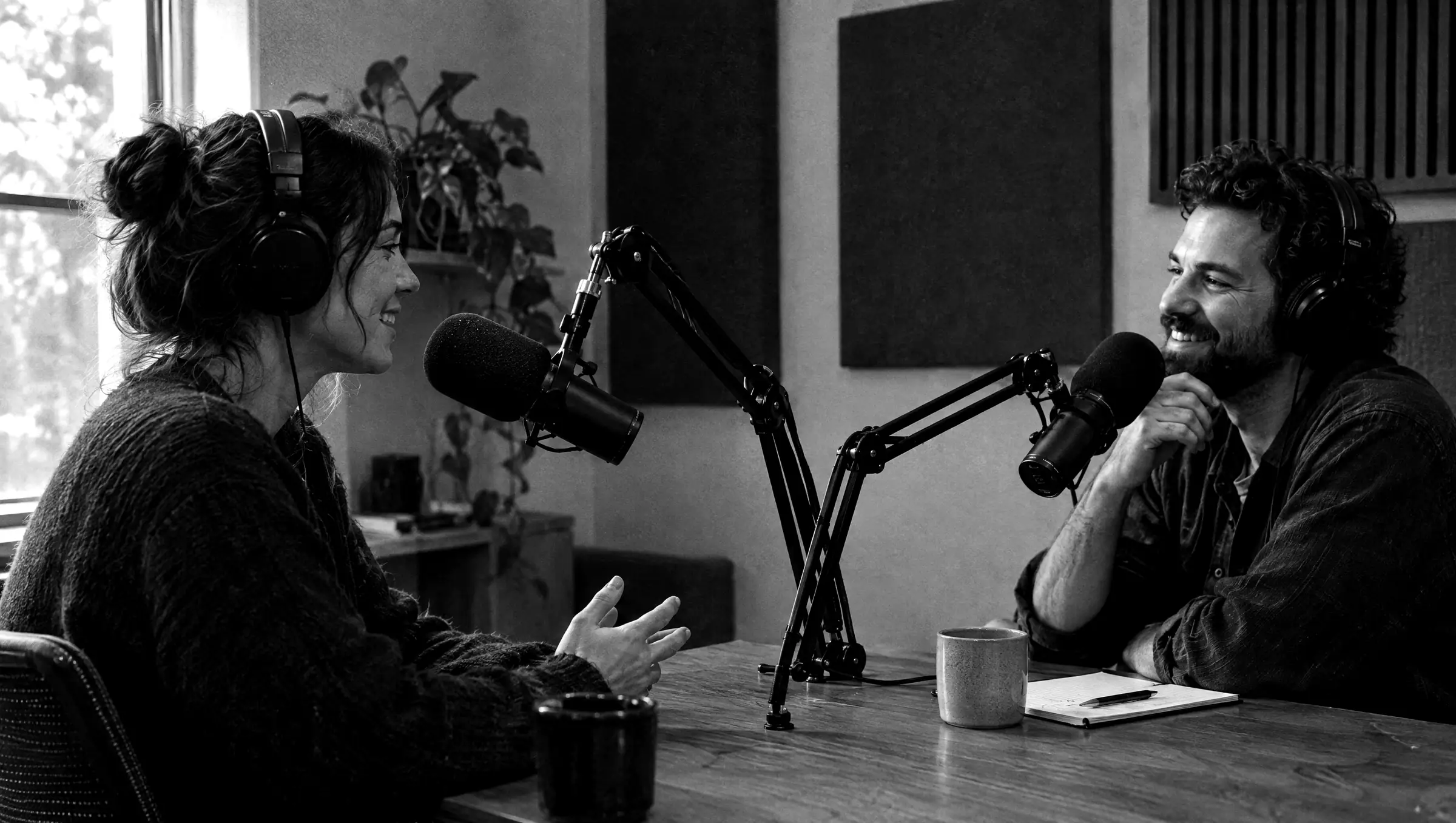 Two people recording a podcast in a small studio